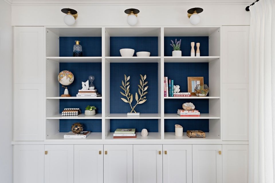 Blue behind built in bookshelf by Rebecca Hay white white cabinets