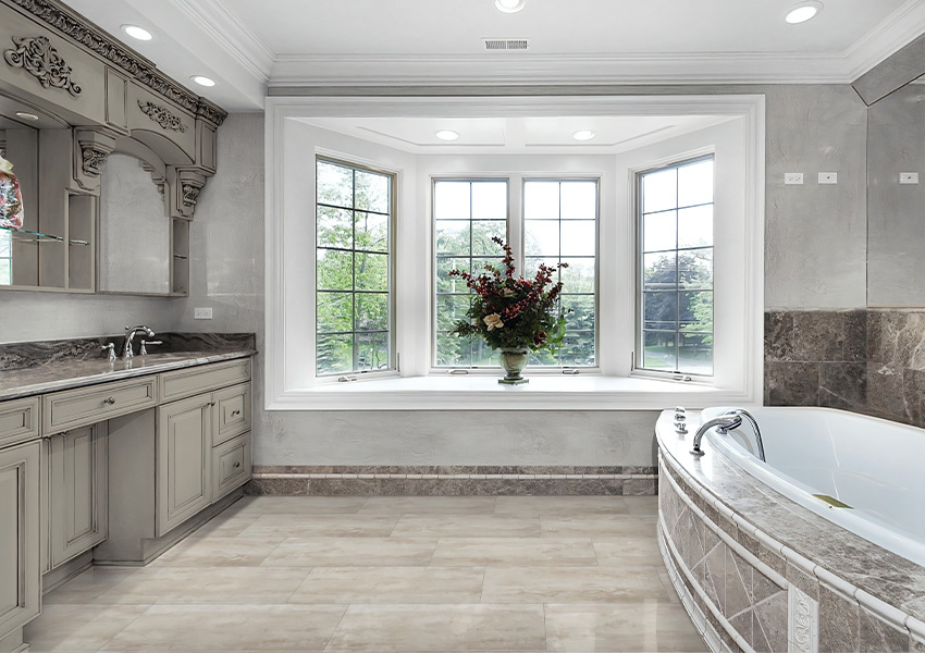 stone look luxury vinyl tile flooring in bathroom with stone bathtub